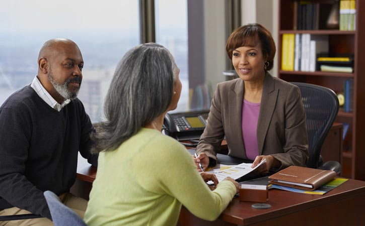 An older couple speaks with a financial advisor.