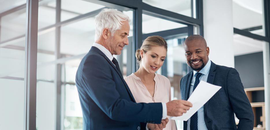 A financial advisor speaks to a man and woman.