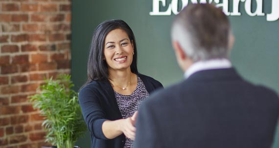 A smiling woman handshake with other person