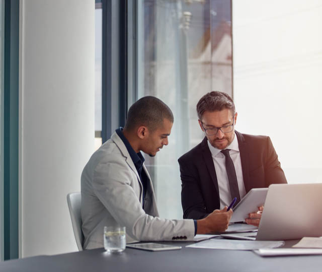two businessmen having an office meeting