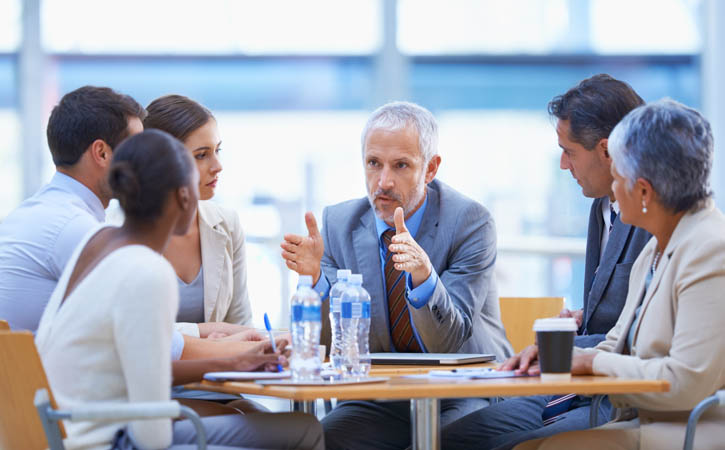 a businessman sharing an idea with colleagues at a meeting