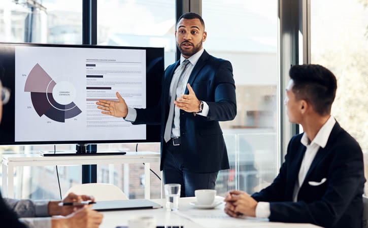 A financial advisor giving a presentation in a room in front of people